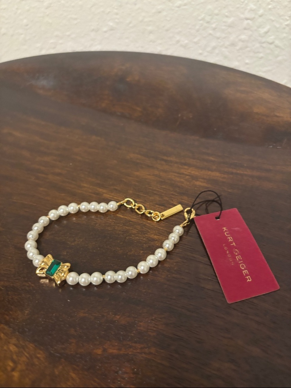 Kurt Geiger Gold Pearl Bracelet with Green Stone